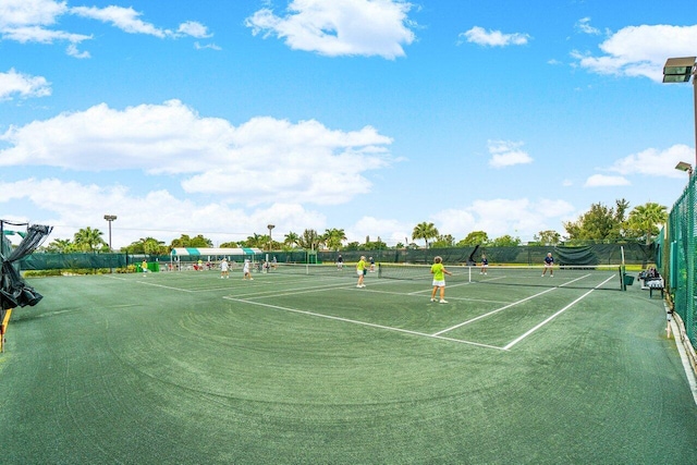 view of tennis court featuring fence