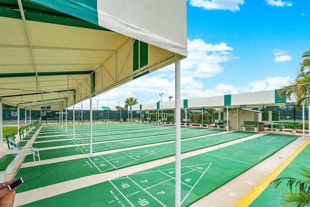 view of community featuring shuffleboard and fence