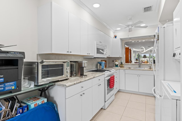 kitchen featuring a ceiling fan, a sink, a toaster, white appliances, and light tile patterned flooring