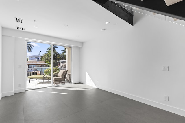 unfurnished room with baseboards, finished concrete floors, and recessed lighting