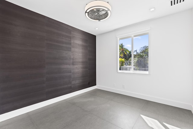unfurnished room with baseboards and recessed lighting