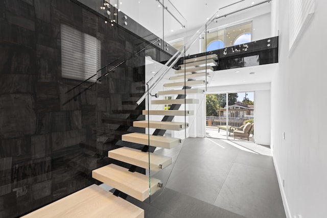 stairs with a high ceiling and baseboards
