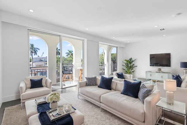 living area with french doors, wood finished floors, recessed lighting, and baseboards