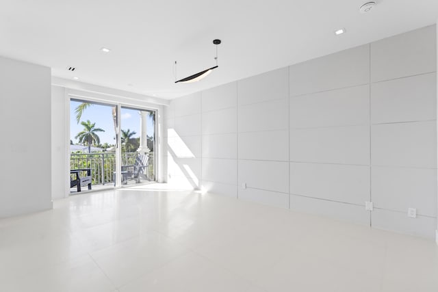 empty room featuring tile patterned floors and recessed lighting