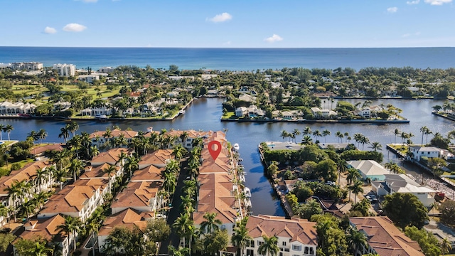 aerial view of property and surrounding area featuring nearby suburban area and a nearby body of water