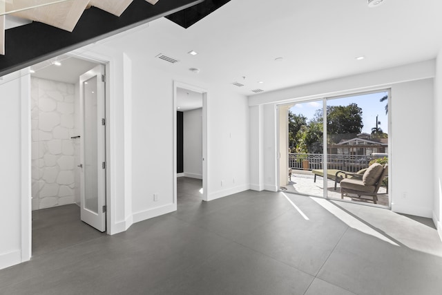 unfurnished living room featuring baseboards and recessed lighting