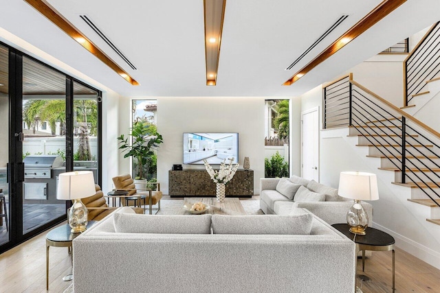 1445 NE 5th Ave, Boca Raton, FL 33432 - living area featuring stairs, wood finished floors, and baseboards