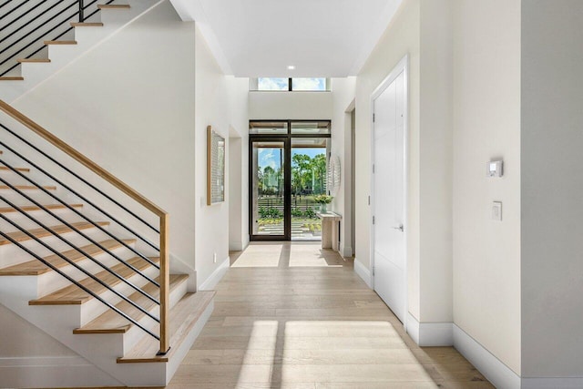 1445 NE 5th Ave, Boca Raton, FL 33432 - entryway with stairs, light wood-type flooring, and baseboards
