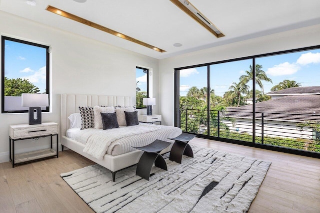 1445 NE 5th Ave, Boca Raton, FL 33432 - bedroom featuring access to outside, light wood-type flooring, and multiple windows