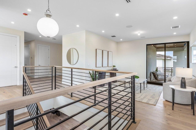 1445 NE 5th Ave, Boca Raton, FL 33432 - hallway with an upstairs landing, light wood finished floors, and recessed lighting