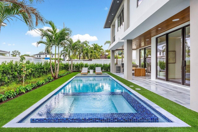 1445 NE 5th Ave, Boca Raton, FL 33432 - view of pool with a fenced backyard, a patio area, and a pool with connected hot tub