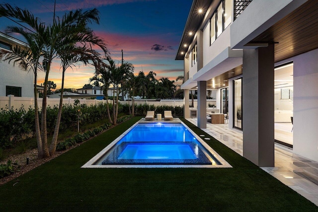 1445 NE 5th Ave, Boca Raton, FL 33432 - pool at dusk featuring a patio area and a pool with connected hot tub