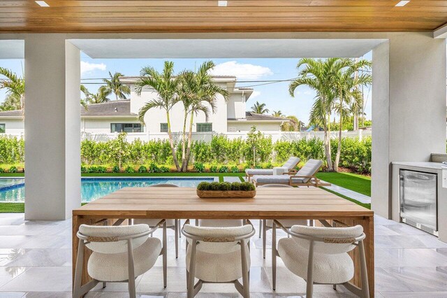 1445 NE 5th Ave, Boca Raton, FL 33432 - view of patio with a fenced backyard, outdoor dining space, and beverage cooler