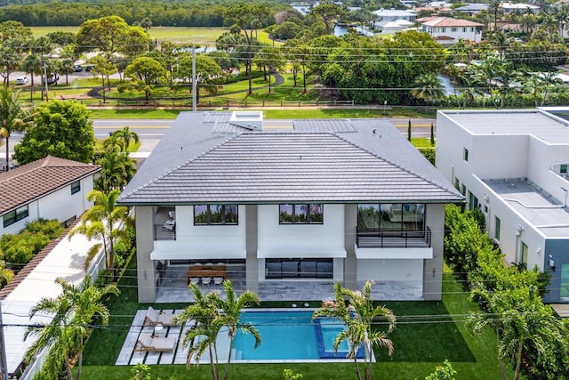 1445 NE 5th Ave, Boca Raton, FL 33432 - back of property with a balcony, stucco siding, a patio, and a tile roof