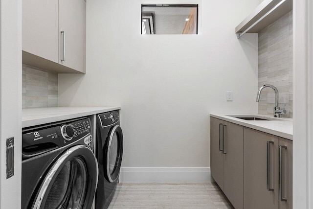 1445 NE 5th Ave, Boca Raton, FL 33432 - clothes washing area featuring separate washer and dryer, cabinet space, baseboards, and light wood finished floors