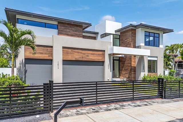 1445 NE 5th Ave, Boca Raton, FL 33432 - contemporary house featuring a fenced front yard, stucco siding, and stone siding