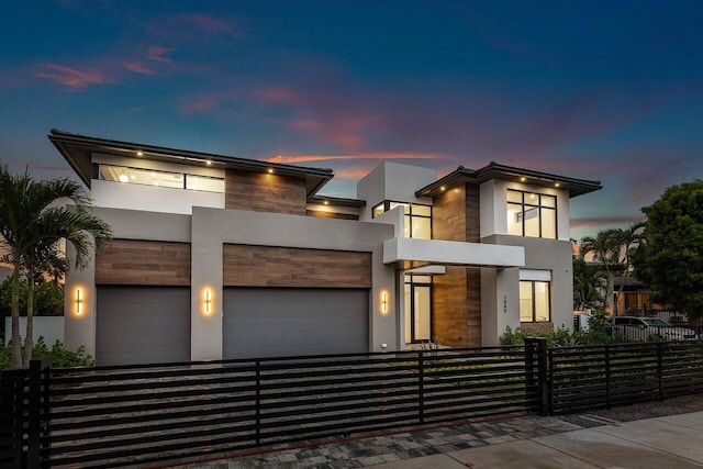1445 NE 5th Ave, Boca Raton, FL 33432 - contemporary house with a fenced front yard, a garage, stone siding, stucco siding, and driveway