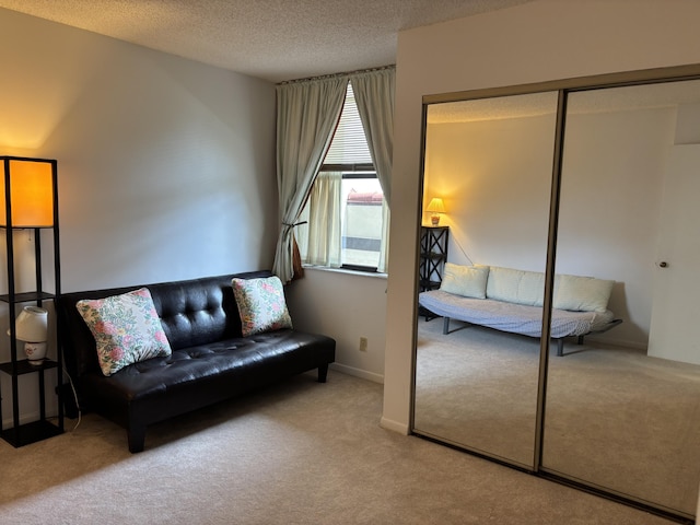 825 Egret Cir Unit 205, Delray Beach, FL 33444 - sitting room with carpet flooring and a textured ceiling
