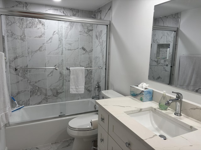 825 Egret Cir Unit 205, Delray Beach, FL 33444 - full bathroom featuring marble look tile flooring, toilet, bath / shower combo with glass door, and vanity