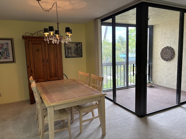 825 Egret Cir Unit 205, Delray Beach, FL 33444 - dining area with light colored carpet, a chandelier, a textured ceiling, and a wall of windows