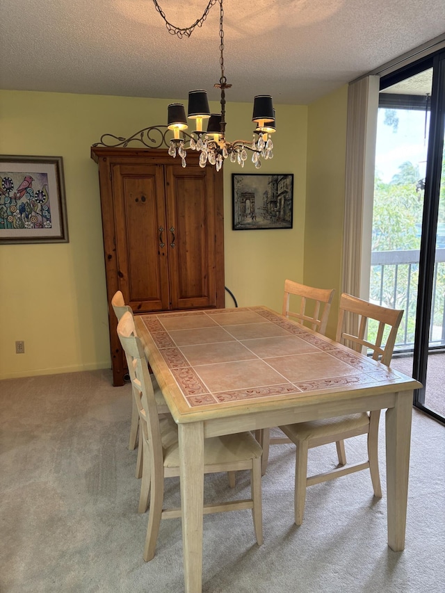825 Egret Cir Unit 205, Delray Beach, FL 33444 - dining room featuring light colored carpet, a chandelier, a textured ceiling, and a wall of windows