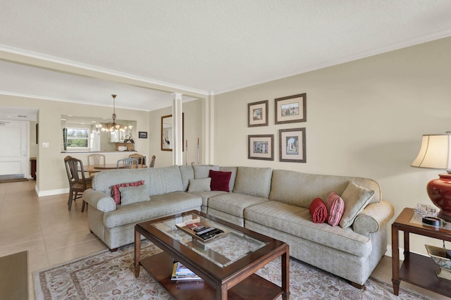 10200 S Ocean Dr Unit 303, Jensen Beach, FL 34957 - living room featuring a chandelier, light tile patterned flooring, crown molding, and baseboards