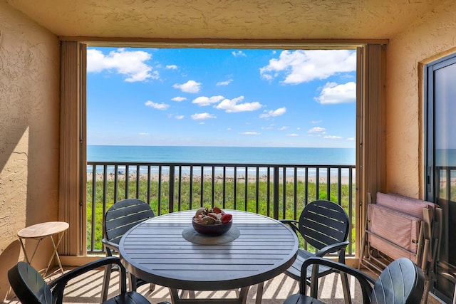 10200 S Ocean Dr Unit 303, Jensen Beach, FL 34957 - balcony featuring a water view, outdoor dining area, and a view of the beach