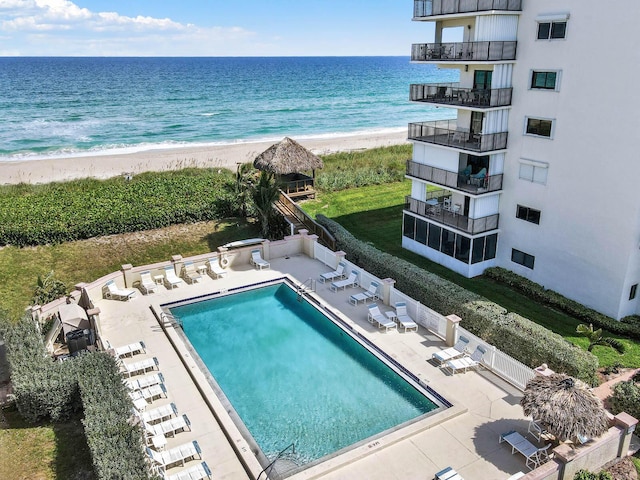 10200 S Ocean Dr Unit 303, Jensen Beach, FL 34957 - community pool featuring a patio area, a water view, and a beach view