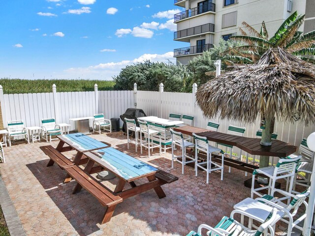 10200 S Ocean Dr Unit 303, Jensen Beach, FL 34957 - view of patio featuring fence and outdoor dining space
