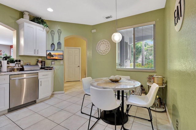 2125 Oakmont Dr, Riviera Beach, FL 33404 - kitchen with white cabinets, stainless steel dishwasher, arched walkways, decorative light fixtures, and light countertops
