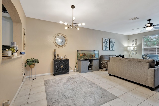 2125 Oakmont Dr, Riviera Beach, FL 33404 - living room with ceiling fan with notable chandelier, visible vents, baseboards, tile patterned flooring, and arched walkways