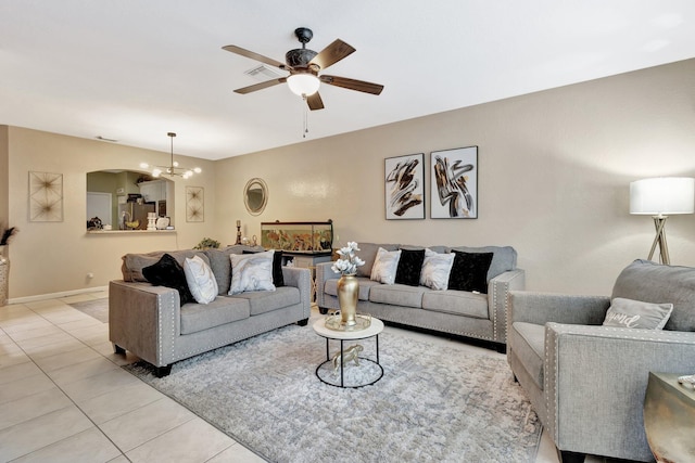 2125 Oakmont Dr, Riviera Beach, FL 33404 - living room with light tile patterned floors, baseboards, visible vents, and ceiling fan with notable chandelier