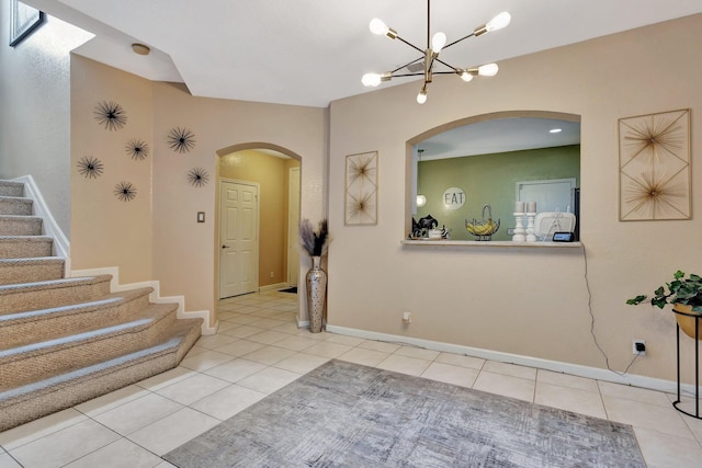 2125 Oakmont Dr, Riviera Beach, FL 33404 - foyer entrance with tile patterned floors, stairway, baseboards, and arched walkways