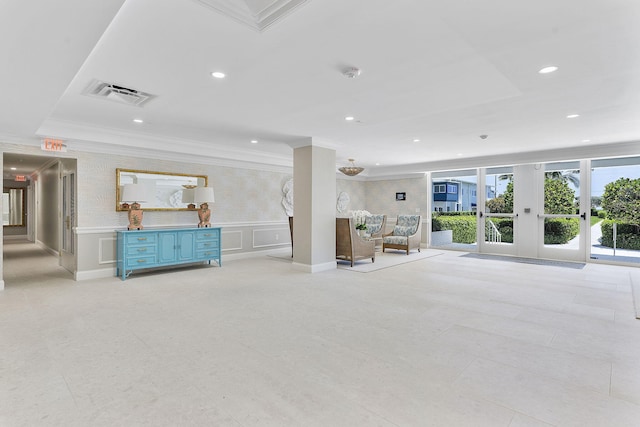 unfurnished living room featuring ornamental molding, recessed lighting, french doors, a decorative wall, and wainscoting