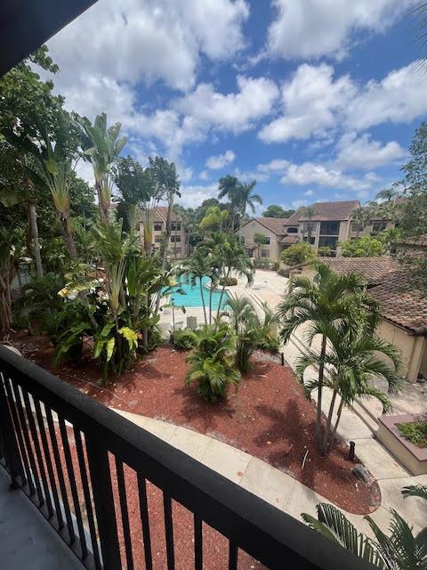 balcony featuring view of pool area