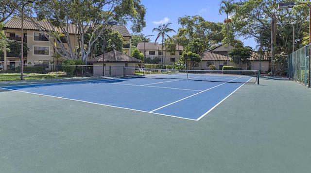 view of tennis court with fence