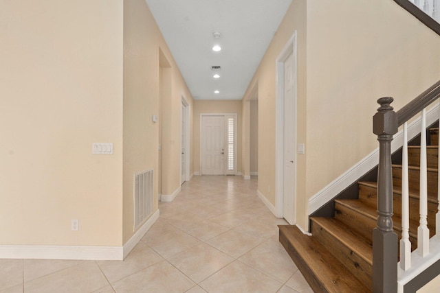 corridor with light tile patterned flooring, visible vents, recessed lighting, stairway, and baseboards