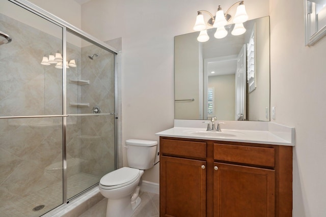 full bath featuring toilet, vanity, tile patterned floors, a stall shower, and a chandelier
