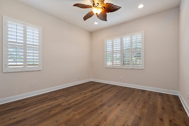 spare room with baseboards, recessed lighting, a ceiling fan, and dark wood-type flooring