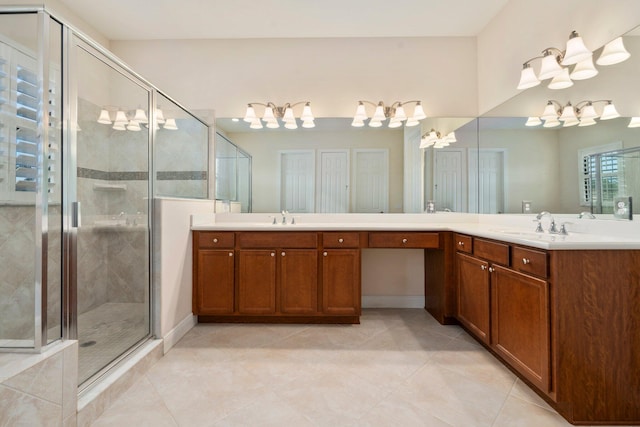 full bathroom with tile patterned floors, an inviting chandelier, a stall shower, and a sink