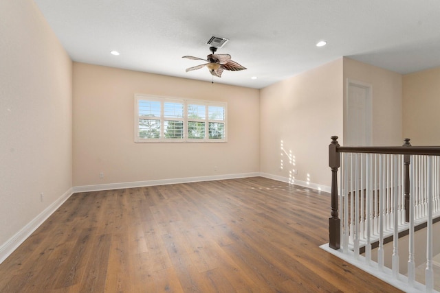 unfurnished room featuring recessed lighting, baseboards, ceiling fan, visible vents, and wood finished floors