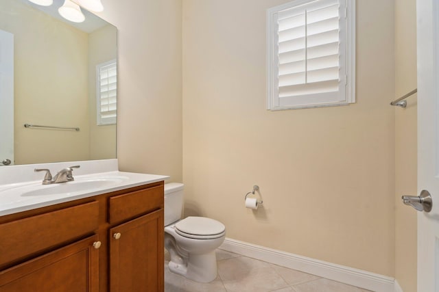 bathroom with tile patterned floors, toilet, baseboards, and vanity