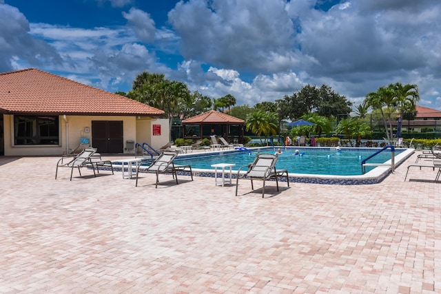 pool featuring a patio and fence