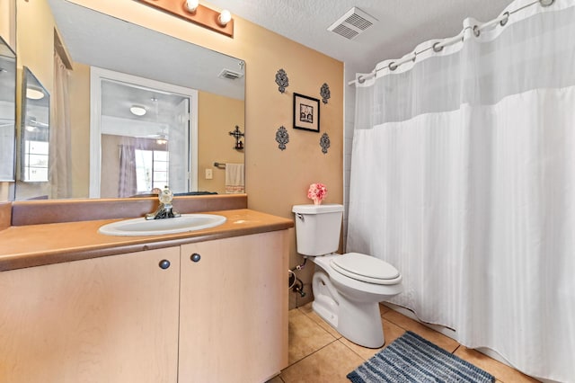 4240 San Marino Blvd Unit 108, West Palm Beach, FL 33409 - bathroom featuring tile patterned flooring, toilet, vanity, a textured ceiling, and a shower with shower curtain
