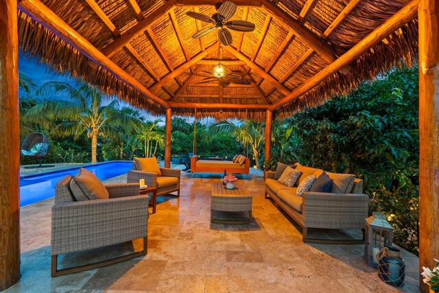 view of patio with a gazebo, an outdoor living space, a ceiling fan, and an outdoor pool