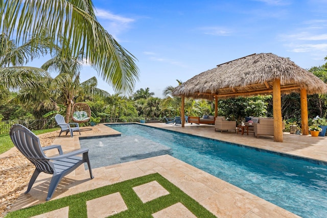 outdoor pool with an outdoor hangout area, a gazebo, a patio, and fence