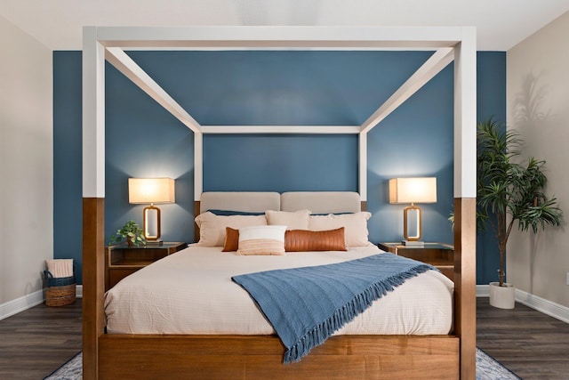 bedroom with baseboards and wood finished floors