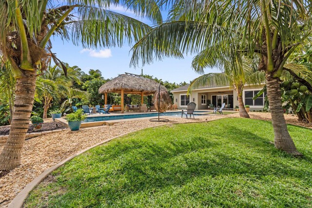 exterior space featuring a yard, a gazebo, a patio area, and a ceiling fan