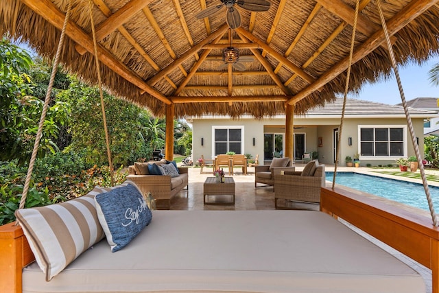 view of patio / terrace featuring an outdoor pool, a gazebo, a ceiling fan, and an outdoor living space