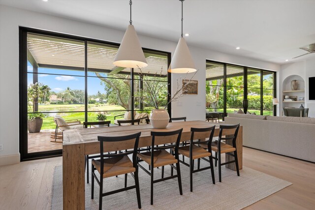 dining room with light wood-style floors and recessed lighting